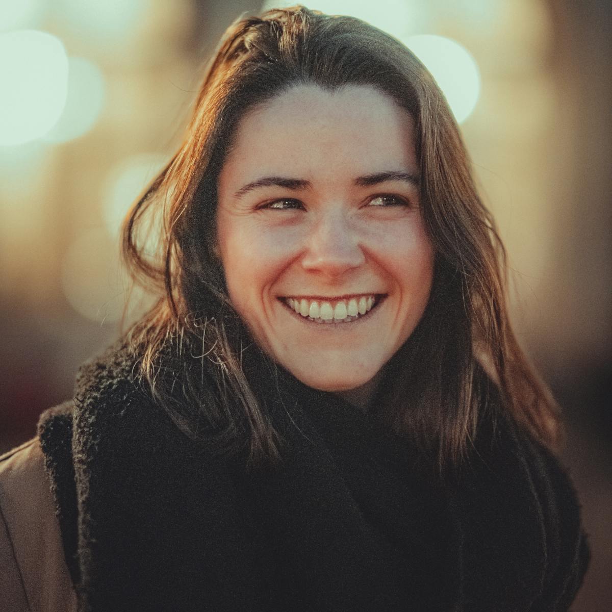 A warmly smiling adult in golden-hour light - representing hopeful, physician-supervised ketamine therapy at Ascend Mind and Body in Wesley Chapel