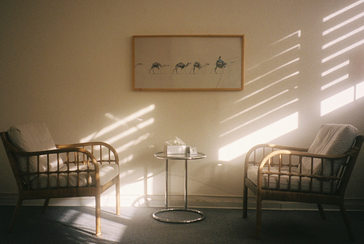 A calm, softly lit clinical interior with comfortable seating in natural light, illustrative of a monitored, unhurried dosing setting.